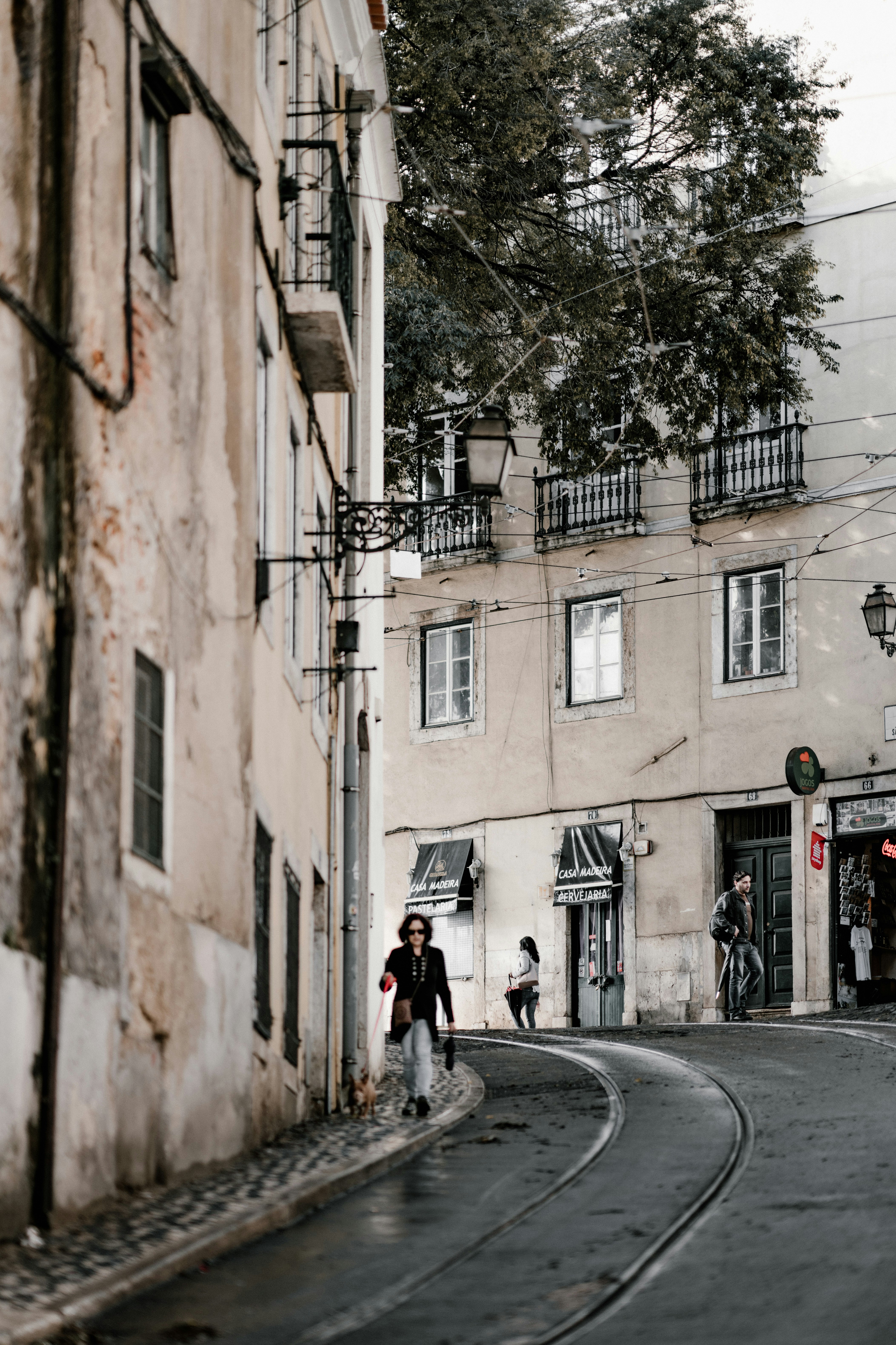 man walking near white concrete buildings